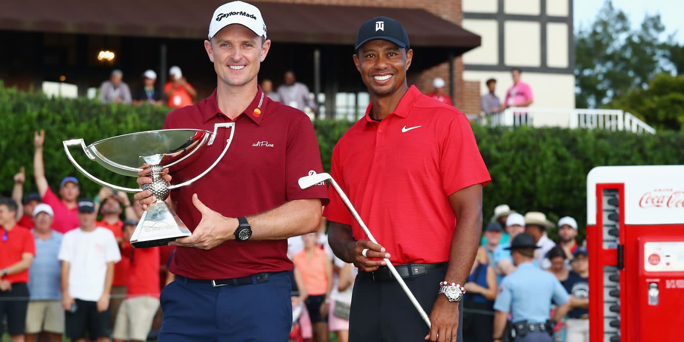 Justin Rose and Tiger with their respective trophies