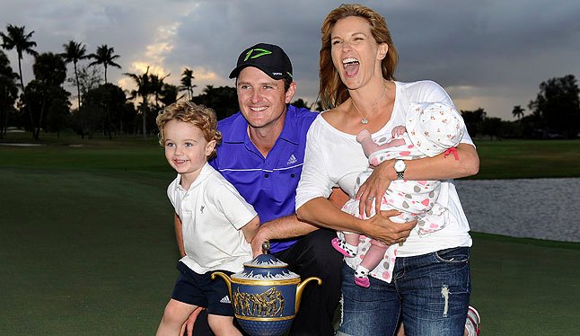 Justin Rose gives his son a trophy