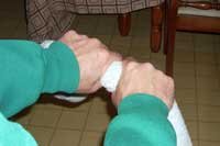 Wringing towel with both hands on top
