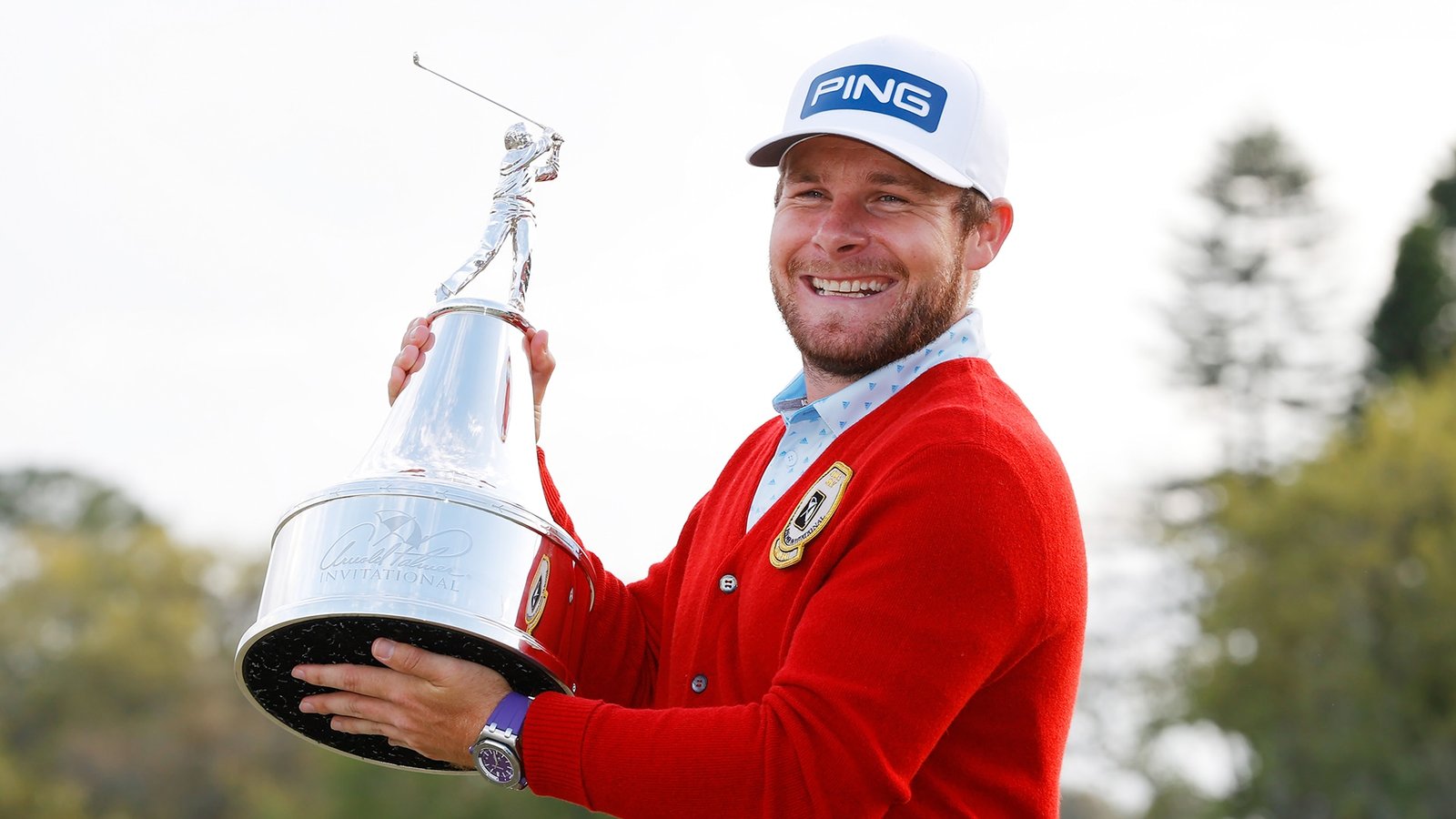 Tyrrell Hatton with API trophy and cardigan