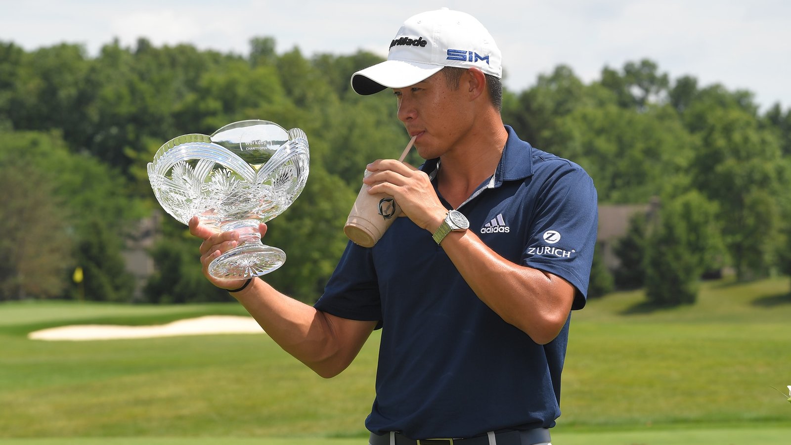 Collin Morikawa with the Workday trophy and a milkshake