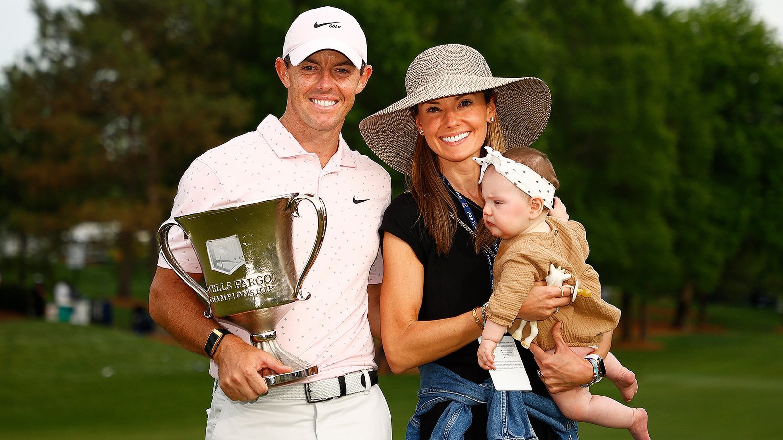 Rory, his wife and his daughter with the Wells Fargo trophy